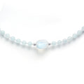 Close up detail of natural Rainbow Moonstone focal bead on light blue Aquamarine beads with S925 silver spacers
