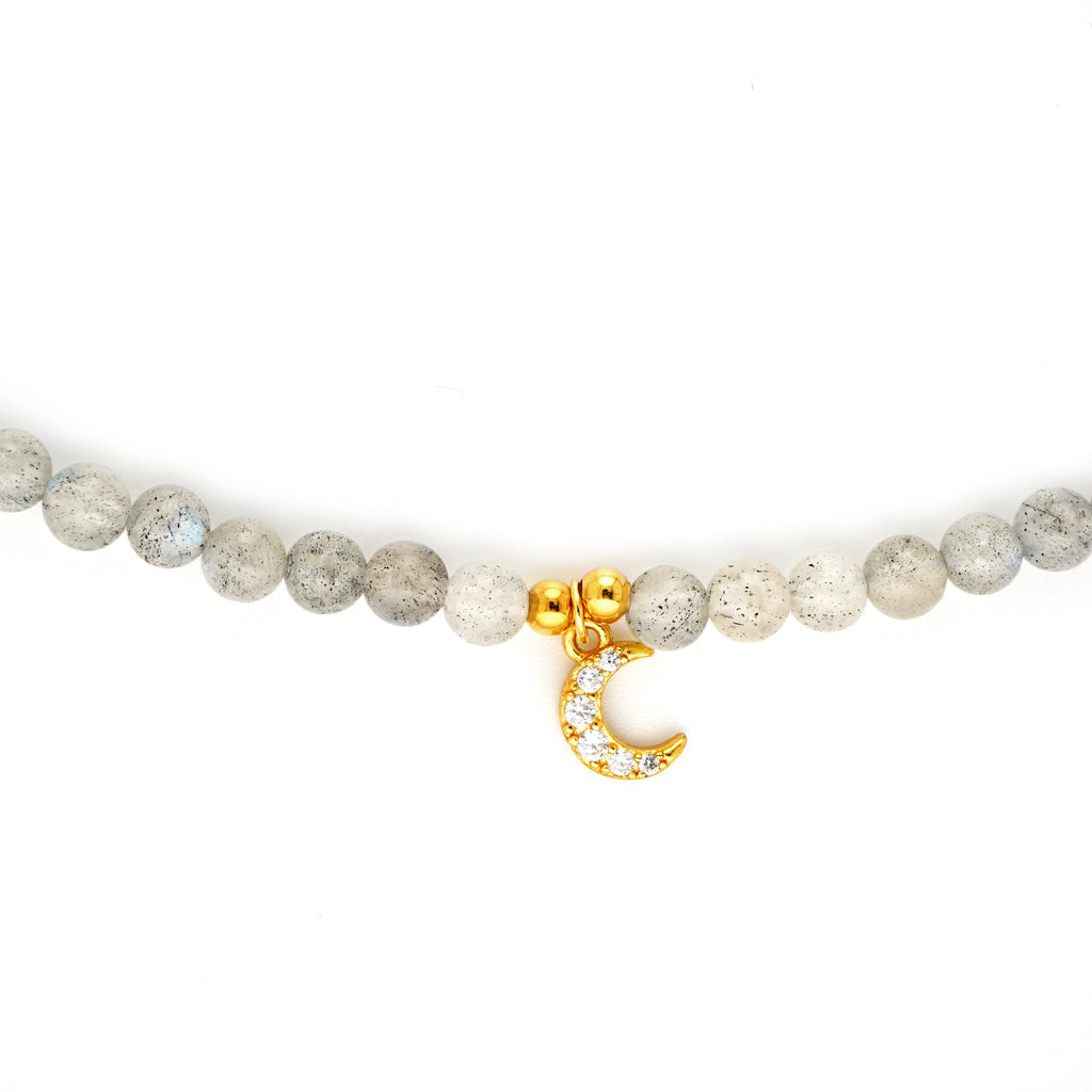 Close up detail of 18k gold plated S925 silver CZ crescent moon charm on natural Labradorite beads
