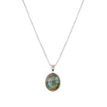 A silver chain necklace with an oval pendant featuring a natural labradorite stone with iridescent blue, green, and gold flecks, set in a silver bezel.