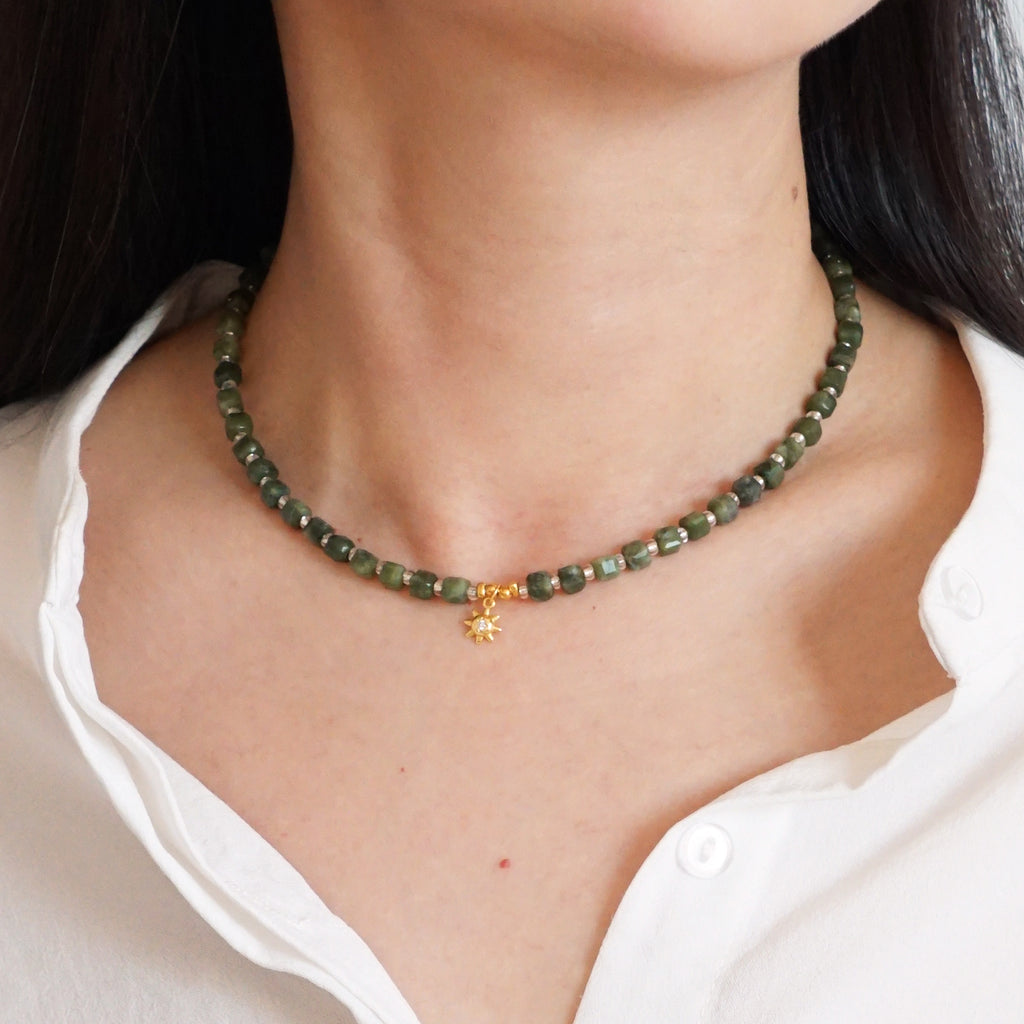 Natural cut green Southern Jade beaded sunburst choker necklace worn on model neck

