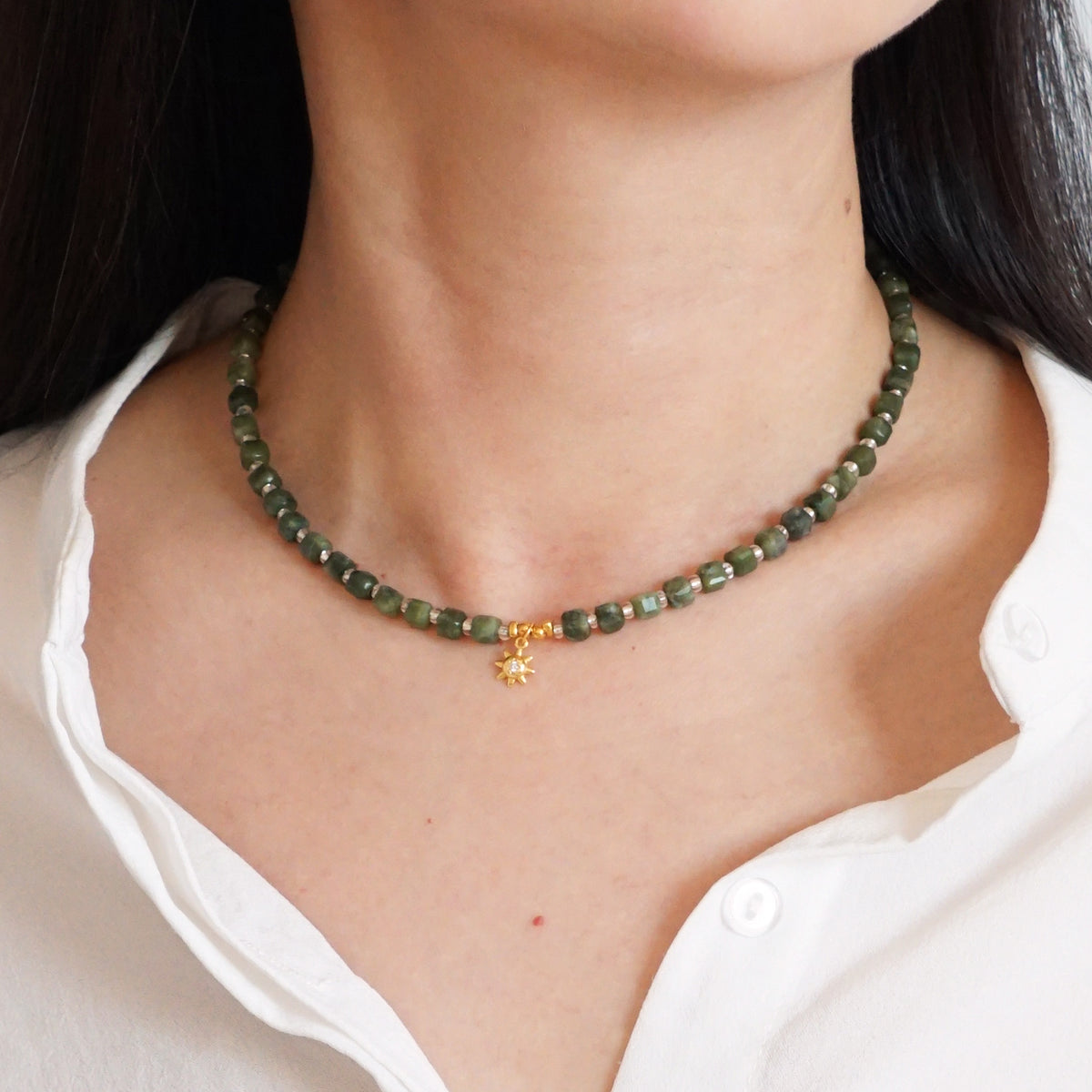 Natural cut green Southern Jade beaded sunburst choker necklace worn on model neck
