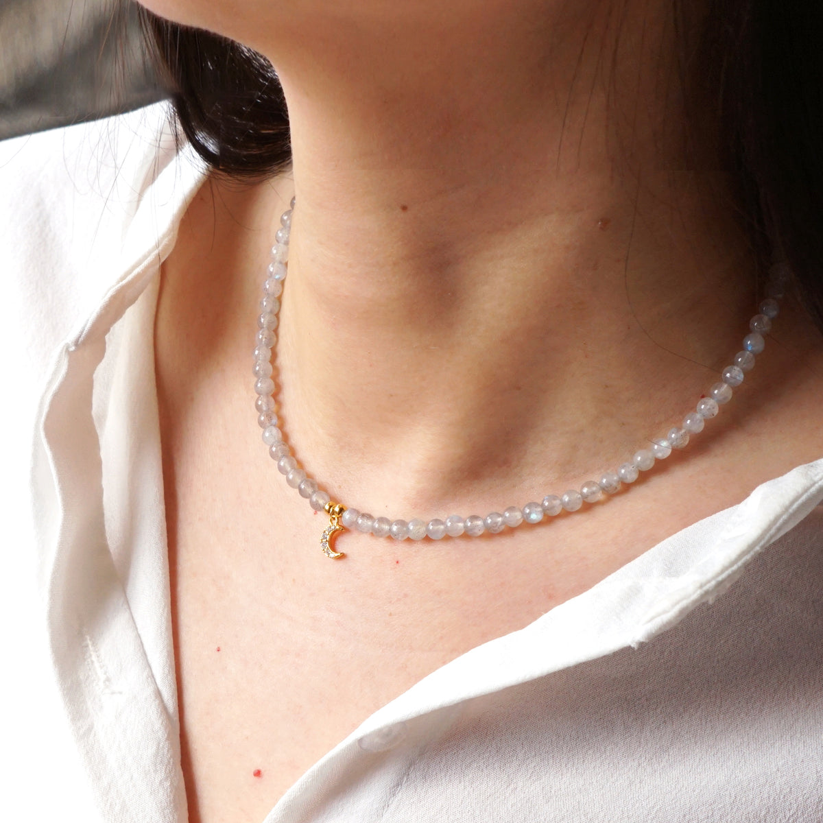 Natural Labradorite beaded moon choker necklace worn on model neck with white shirt
