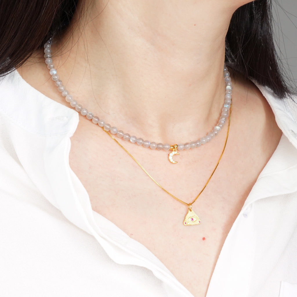 Layered natural Labradorite moon choker and gold Evil Eye triangle pendant necklace set on model
