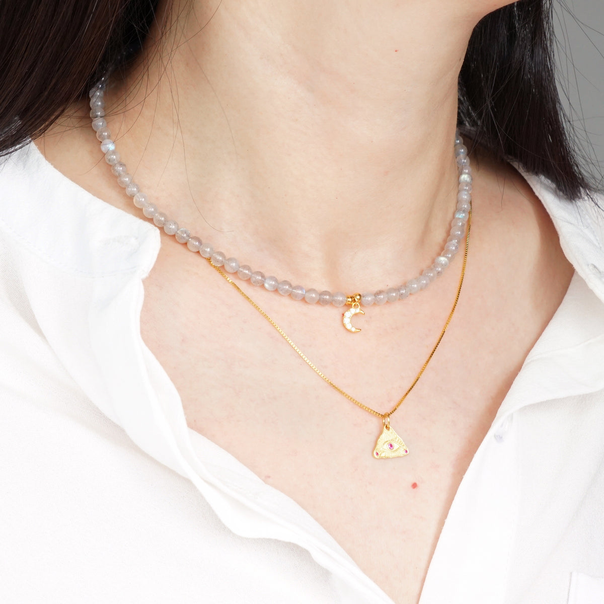 Layered natural Labradorite moon choker and gold Evil Eye triangle pendant necklace set on model
