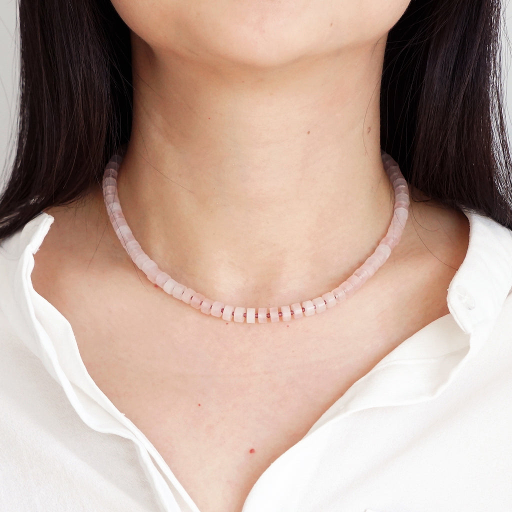 Natural Rose Quartz disc beads choker necklace worn on model neck with white shirt
