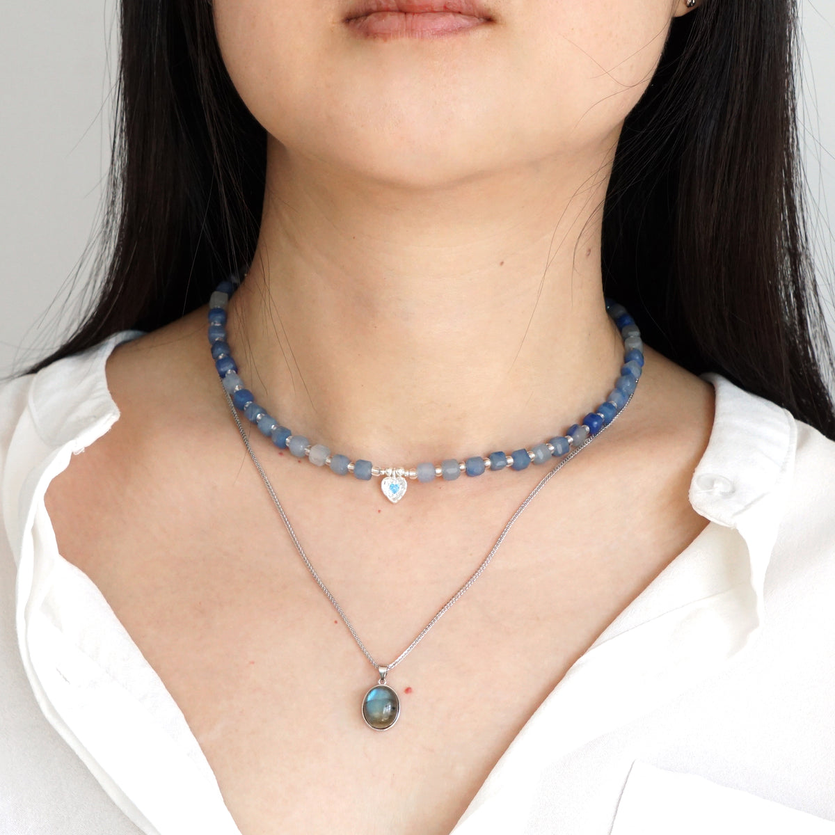 Layered natural Blue Aventurine heart choker and silver Labradorite pendant necklace set on model
