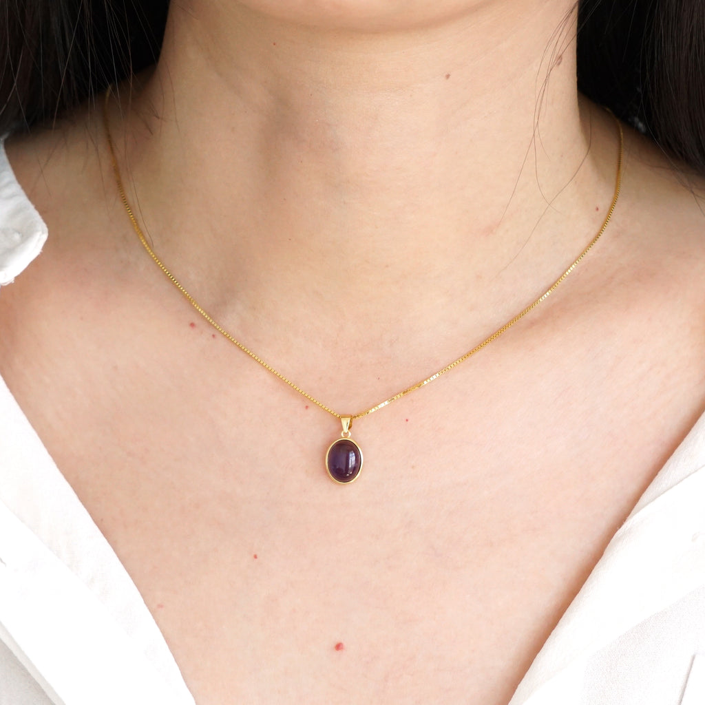Everyday minimalist natural Amethyst oval pendant necklace styled with white shirt on model
